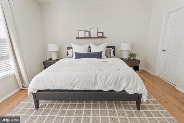 bedroom with wood finished floors and baseboards