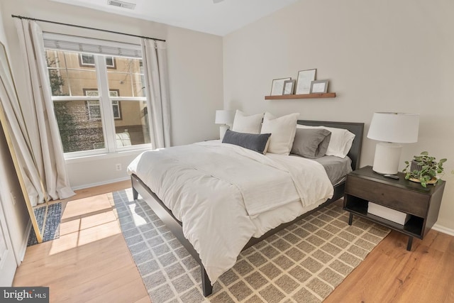 bedroom with light wood-style floors and baseboards
