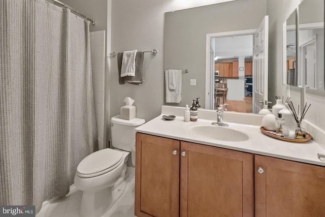 bathroom featuring toilet, tile patterned flooring, vanity, and a shower with curtain