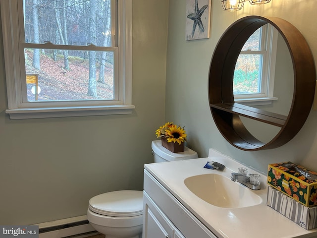 bathroom featuring baseboard heating, toilet, and vanity
