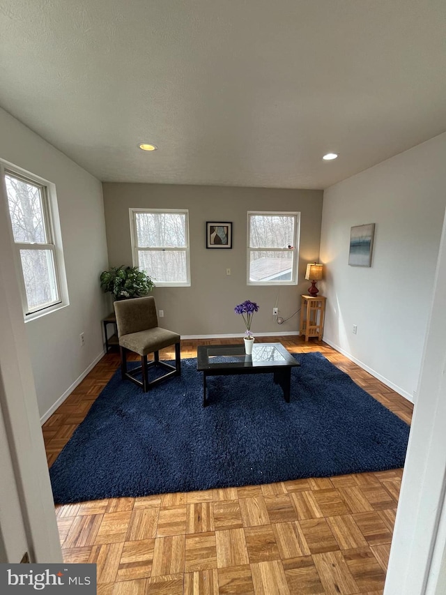 sitting room featuring plenty of natural light, baseboards, and recessed lighting