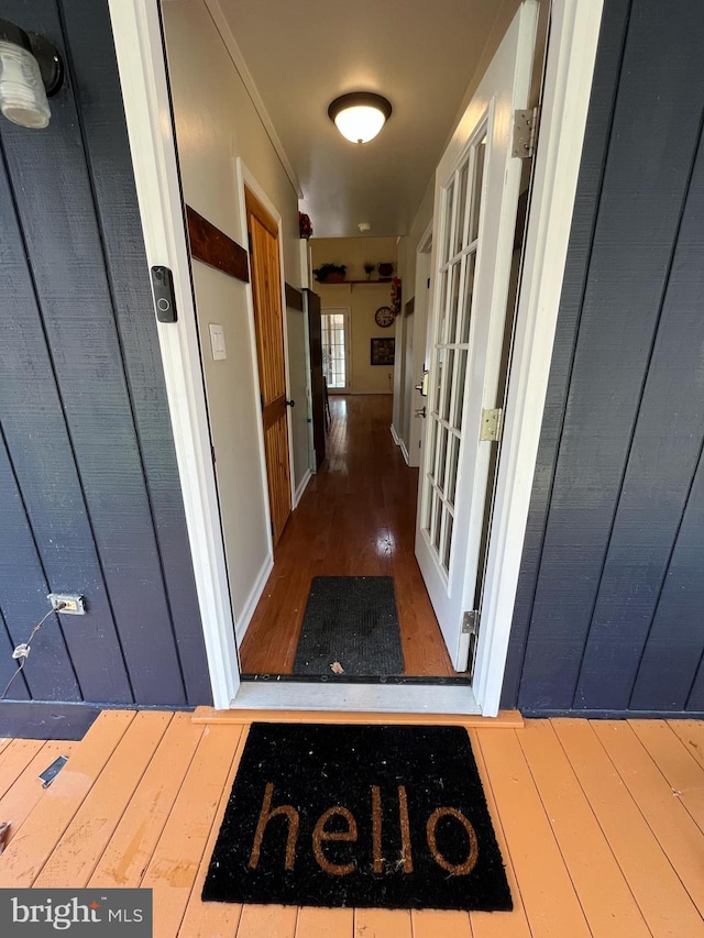 hallway featuring wood finished floors and french doors
