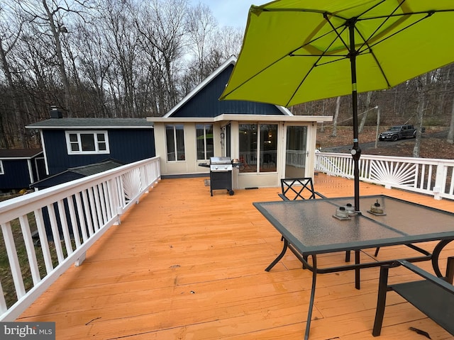deck featuring grilling area and outdoor dining space