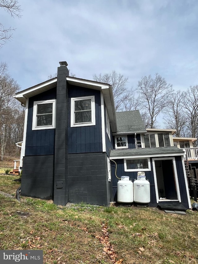 view of side of property featuring a chimney and board and batten siding