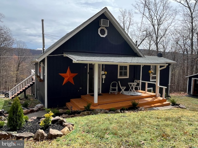rear view of house featuring covered porch