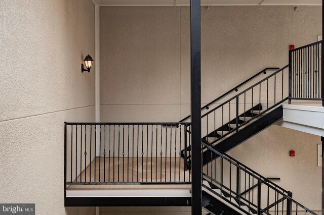 1524 Lincoln Way Unit 409, Mclean, VA 22102 - staircase featuring a textured wall