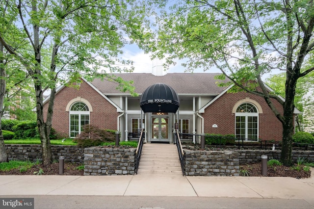 1524 Lincoln Way Unit 409, Mclean, VA 22102 - view of front facade featuring french doors, brick siding, and roof with shingles