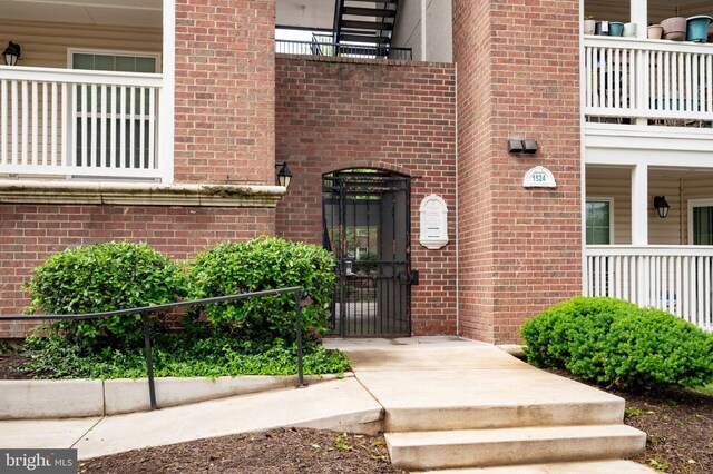 1524 Lincoln Way Unit 409, Mclean, VA 22102 - doorway to property with brick siding and a gate