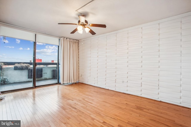 400 Madison St Unit 1704, Alexandria, VA 22314 - empty room featuring wood-type flooring, a ceiling fan, and expansive windows