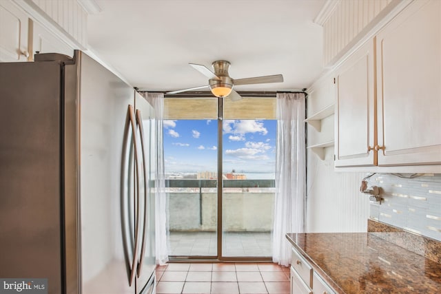 400 Madison St Unit 1704, Alexandria, VA 22314 - kitchen featuring light tile patterned floors, ceiling fan, expansive windows, white cabinets, and freestanding refrigerator