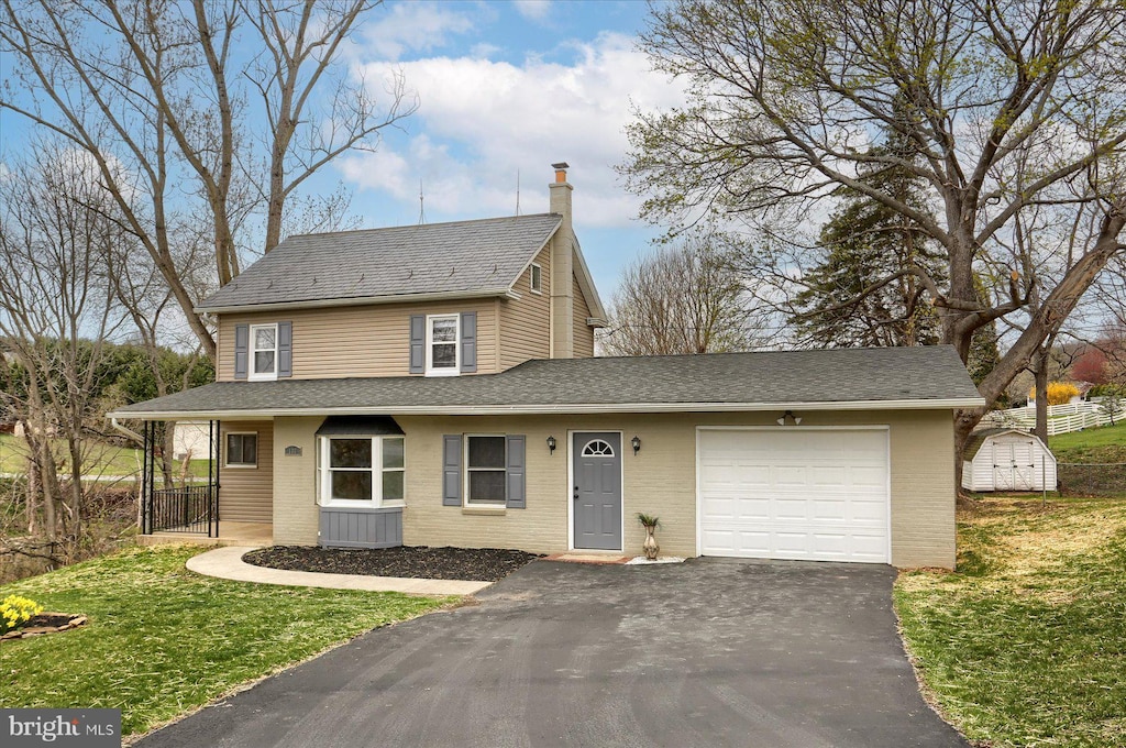 view of front of property with a garage, brick siding, a front lawn, driveway, and a shingled roof