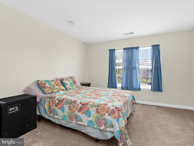 carpeted bedroom with baseboards and visible vents