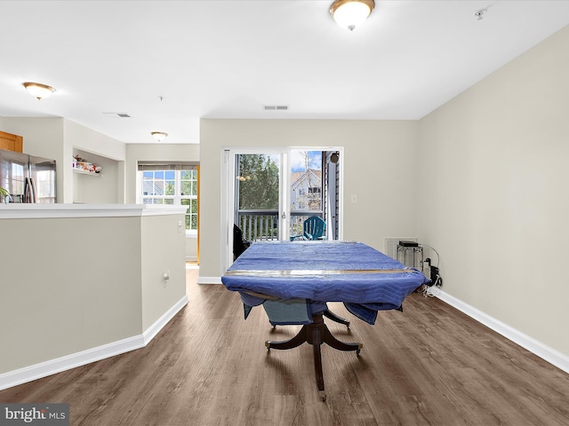 rec room with wood finished floors, baseboards, and visible vents