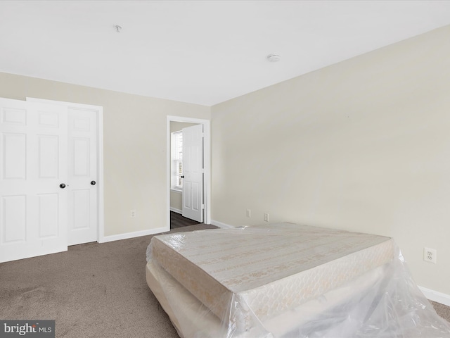 bedroom with baseboards and carpet flooring