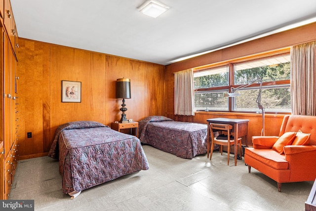 bedroom featuring wooden walls