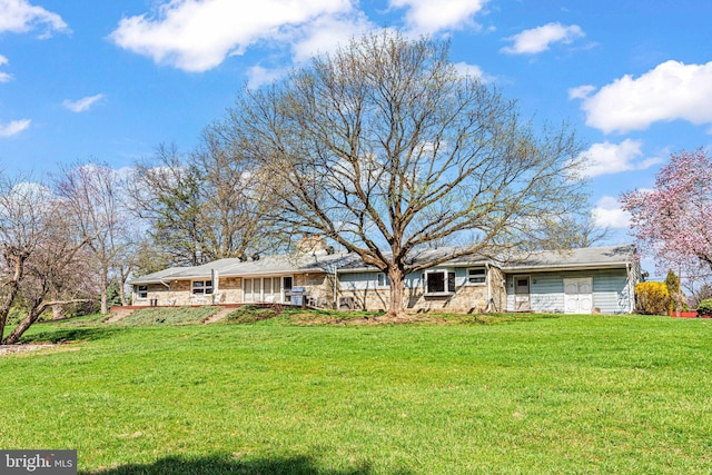 view of front facade with a front lawn and stone siding