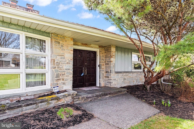 view of exterior entry featuring stone siding