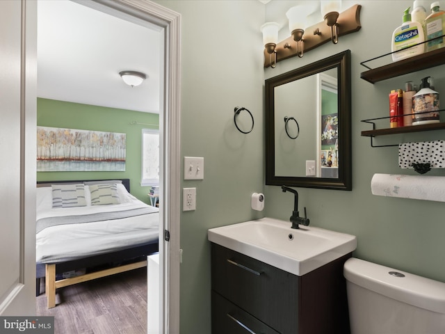 12209 Gable Ln, Fort Washington, MD 20744 - bathroom featuring wood finished floors, toilet, and vanity