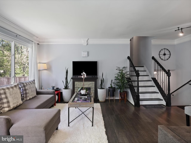 12209 Gable Ln, Fort Washington, MD 20744 - living area featuring a stone fireplace, ornamental molding, wood finished floors, and stairs