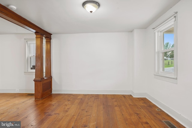 306 W Chapline St, Sharpsburg, MD 21782 - unfurnished room with a smoke detector, decorative columns, and hardwood / wood-style flooring