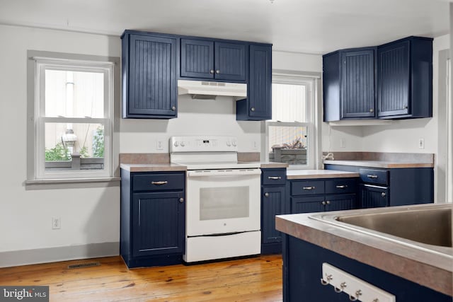 306 W Chapline St, Sharpsburg, MD 21782 - kitchen with white range with electric stovetop, under cabinet range hood, blue cabinets, light wood-type flooring, and light countertops