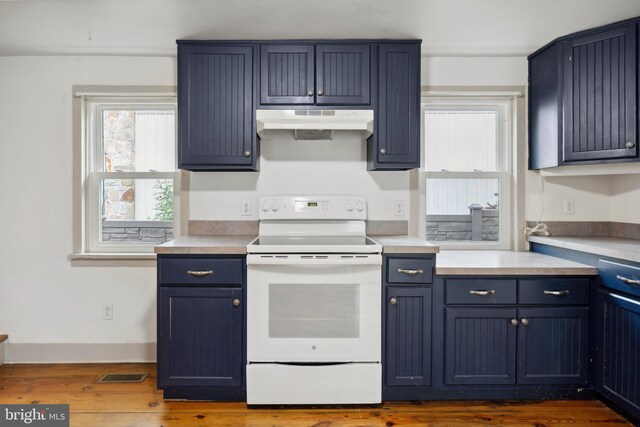 306 W Chapline St, Sharpsburg, MD 21782 - kitchen featuring white electric range oven, under cabinet range hood, dark wood-style floors, and light countertops