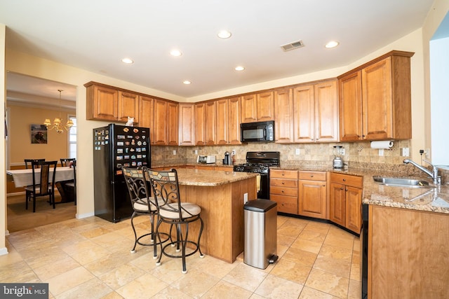 5 Susannah Dr, Chesterfield, NJ 08515 - kitchen with visible vents, a sink, light stone counters, black appliances, and a kitchen breakfast bar