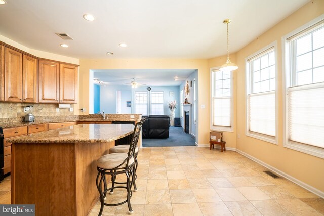 5 Susannah Dr, Chesterfield, NJ 08515 - kitchen with a kitchen breakfast bar, light stone countertops, a center island, and visible vents