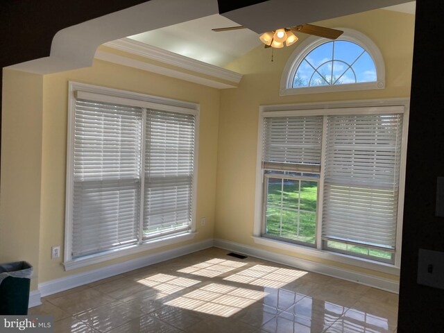 unfurnished dining area with a healthy amount of sunlight, visible vents, baseboards, and ceiling fan