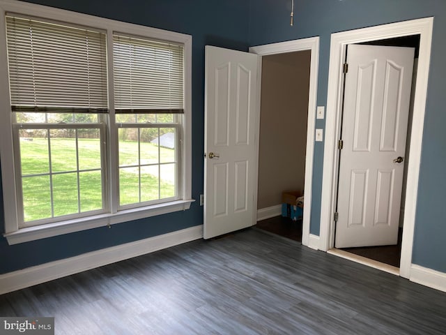unfurnished bedroom featuring baseboards and wood finished floors