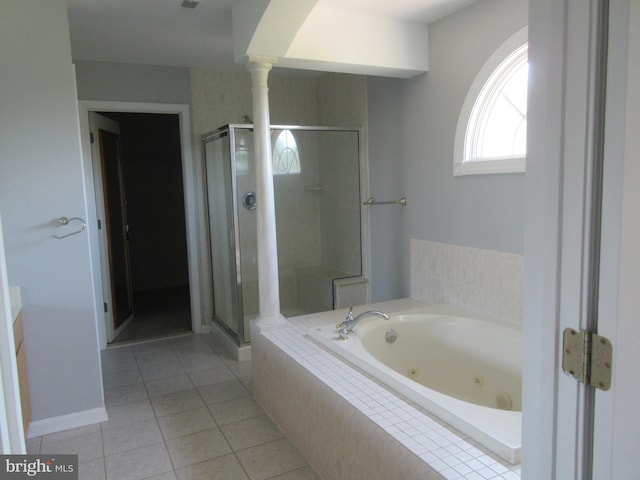 full bath featuring decorative columns, a shower stall, tile patterned flooring, a jetted tub, and baseboards