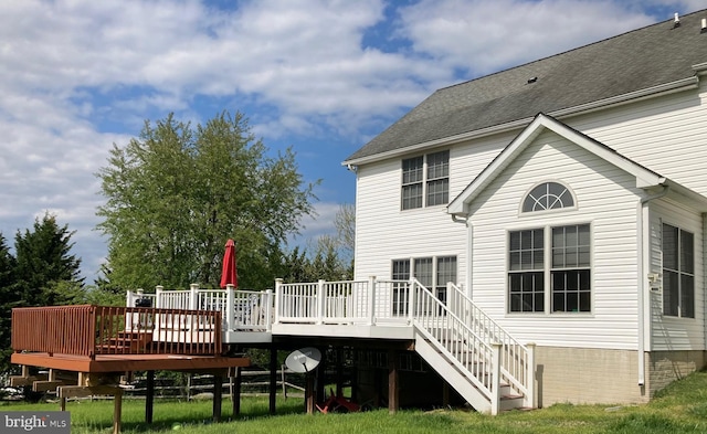 rear view of property featuring a wooden deck and stairway