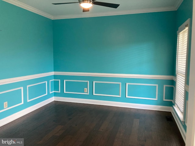 spare room featuring ornamental molding, ceiling fan, dark wood finished floors, and a wainscoted wall