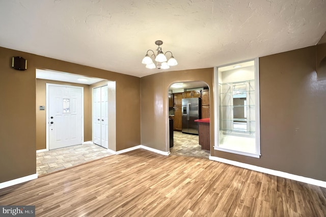 14 Longview Rd, Seven Valleys, PA 17360 - interior space featuring baseboards, a notable chandelier, light wood finished floors, and arched walkways