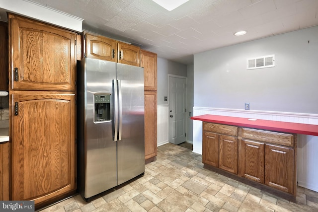 14 Longview Rd, Seven Valleys, PA 17360 - kitchen with brown cabinets, stone finish floor, visible vents, recessed lighting, and stainless steel fridge