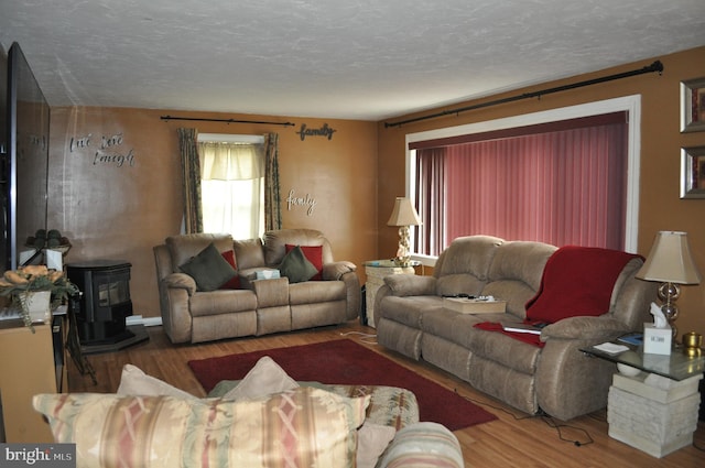 14 Longview Rd, Seven Valleys, PA 17360 - living area featuring a wood stove, a textured ceiling, and wood finished floors