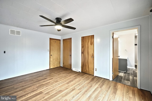 14 Longview Rd, Seven Valleys, PA 17360 - unfurnished bedroom with wood finished floors, a ceiling fan, two closets, visible vents, and ensuite bathroom