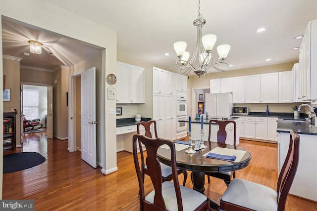 7906 Plum Creek Dr, Gaithersburg, MD 20879 - dining area with recessed lighting, a chandelier, light wood-style flooring, ornamental molding, and baseboards