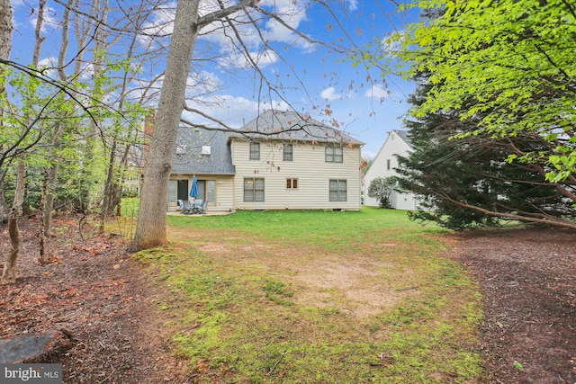 7906 Plum Creek Dr, Gaithersburg, MD 20879 - back of house featuring a shingled roof, a yard, and a patio