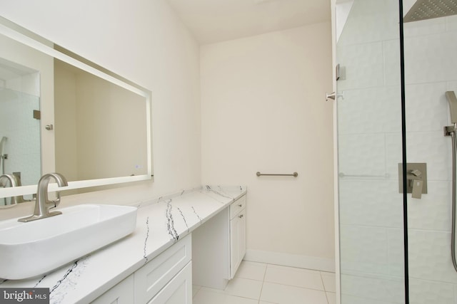 bathroom featuring a shower stall, tile patterned floors, vanity, and baseboards
