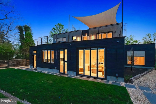 back of property featuring a yard