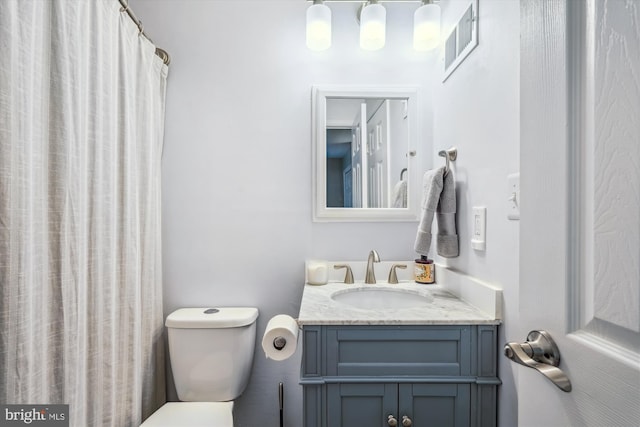 bathroom with vanity, visible vents, and toilet