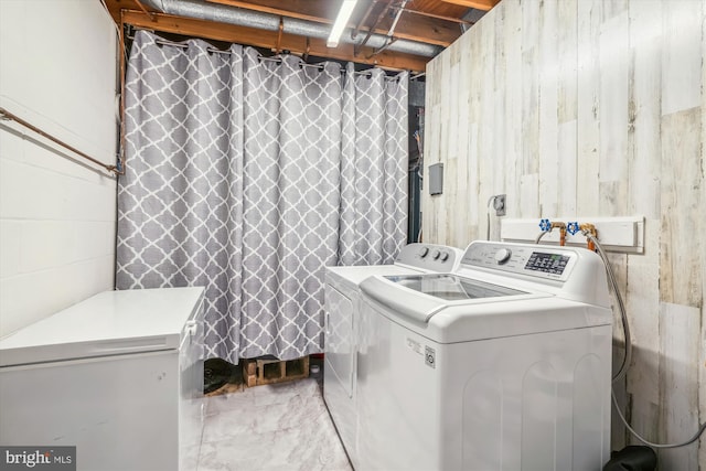 clothes washing area featuring washing machine and dryer and laundry area