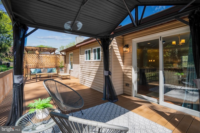wooden terrace with an outdoor hangout area