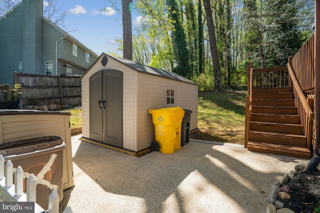 view of shed featuring fence