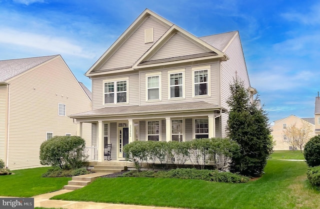 view of front of house featuring a front yard and a porch