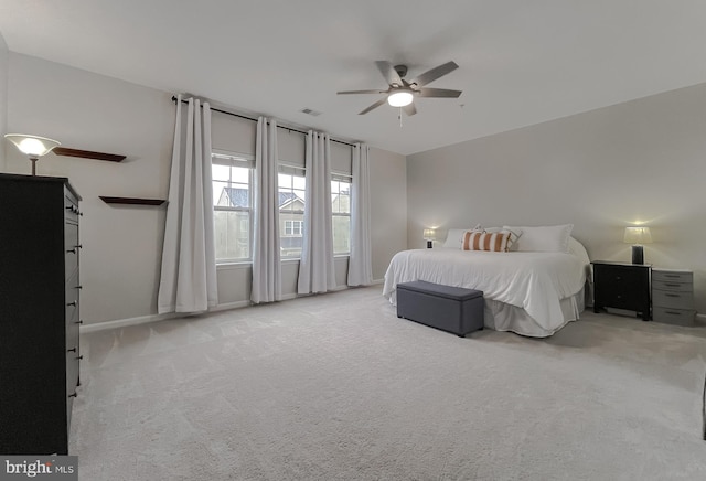 bedroom with light carpet, baseboards, a ceiling fan, and visible vents