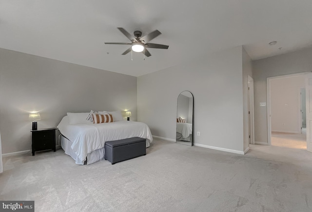 bedroom with light colored carpet, baseboards, and a ceiling fan