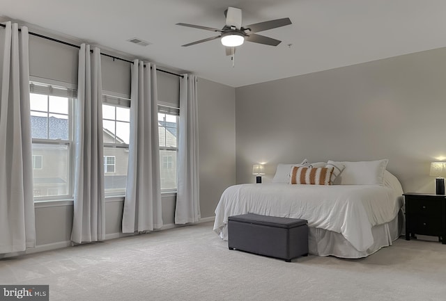 bedroom with visible vents, baseboards, a ceiling fan, and carpet floors