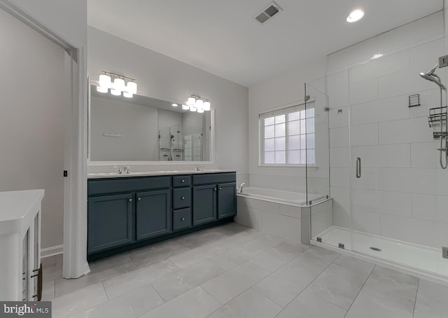 bathroom featuring a bath, visible vents, a sink, a stall shower, and double vanity